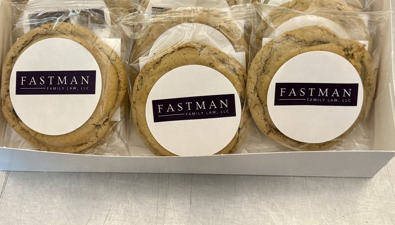 Individually wrapped cookies with custom company logo labels in a corporate gift box from Little Miss Moffitt